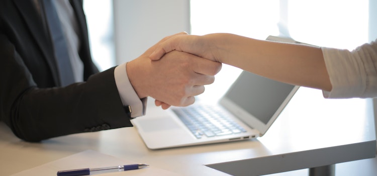 handshake confirming a deal to  a Trusted Software Development Company